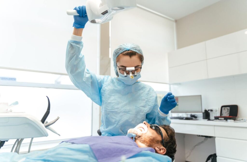 A dentist preparing a patient for dental implant surgery.